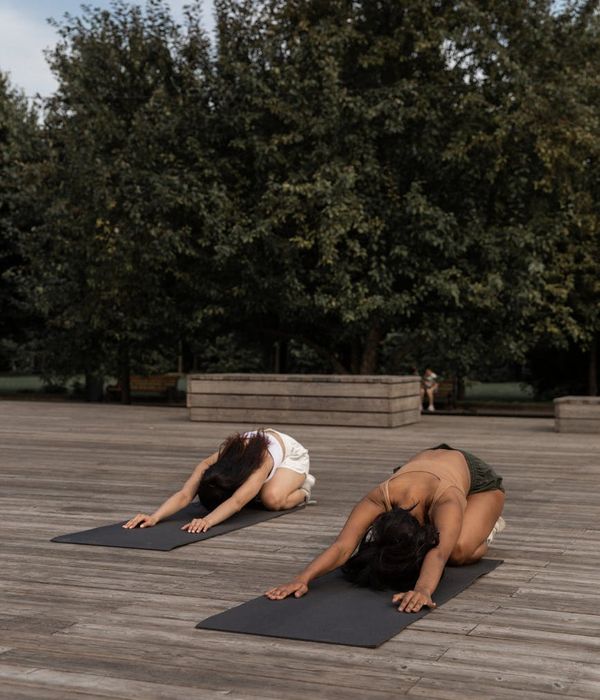 Woman in a calm yoga pose, embodying flexibility and grace.